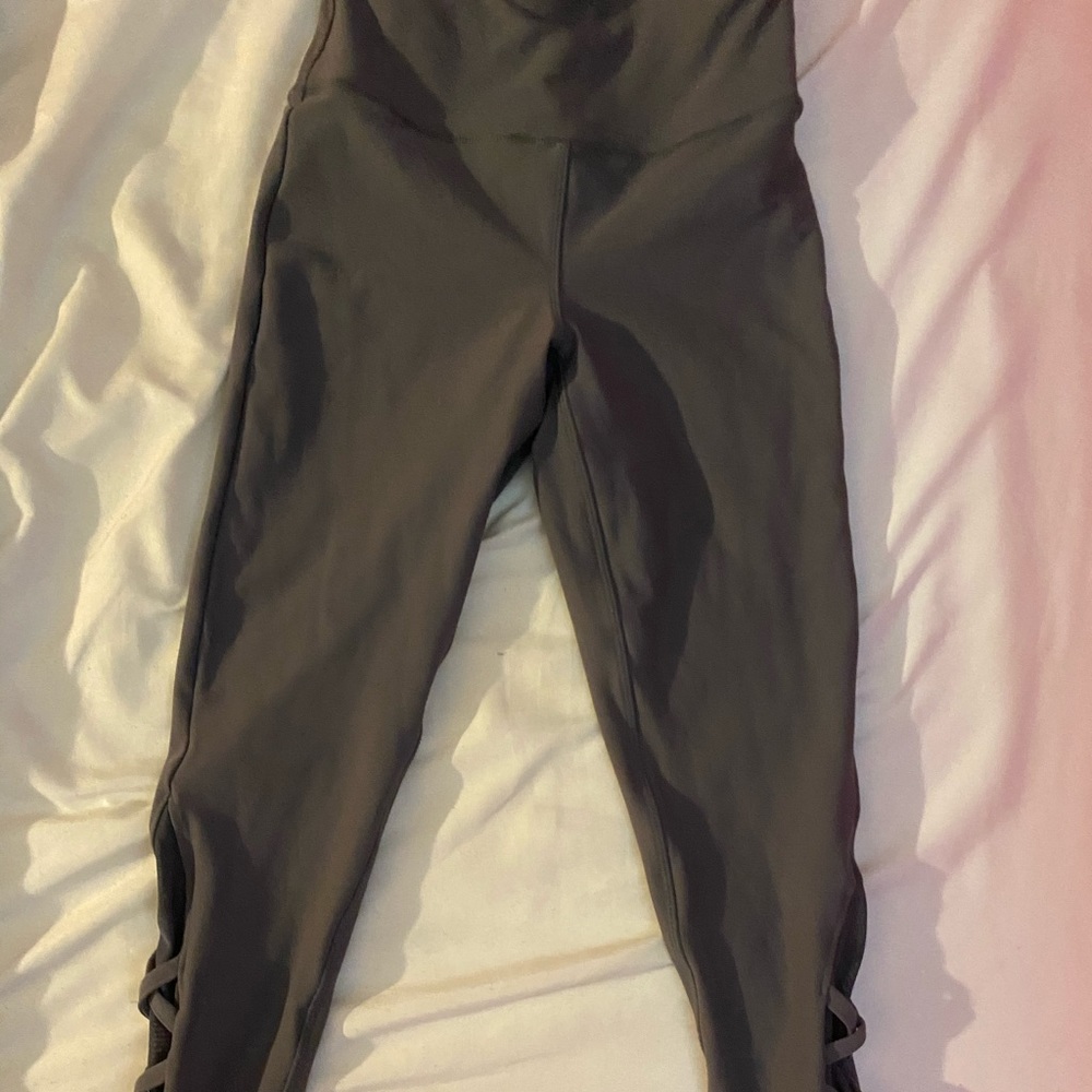 Grey leggings with designs on each leg.